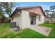 Rear view of home showing patio, lawn, and AC unit with a fenced boundary at 654 Boniview Ln, Altamonte Springs, FL 32714