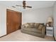 Cozy bedroom features a sofa, closet, ceiling fan, and side table with a lamp at 654 Boniview Ln, Altamonte Springs, FL 32714