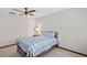 Charming bedroom featuring a floral quilt, side table with lamp, and a ceiling fan at 654 Boniview Ln, Altamonte Springs, FL 32714