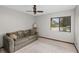 Bedroom with a comfortable sofa, ceiling fan, and bright natural light from the window at 654 Boniview Ln, Altamonte Springs, FL 32714