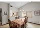 A quaint dining room with an ornate table set for six, a chandelier, and a view to the kitchen at 654 Boniview Ln, Altamonte Springs, FL 32714