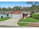 Charming single-story home featuring an attached garage, well-manicured lawn, and landscaping at 654 Boniview Ln, Altamonte Springs, FL 32714
