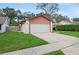 Attached garage with white door, green lawn and trimmed hedges at 654 Boniview Ln, Altamonte Springs, FL 32714