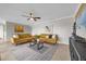 Open living room with a mustard yellow couch and large TV at 670 Lake Villas Dr # D, Altamonte Springs, FL 32701