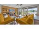 Living room with two mustard yellow sofas and lake view at 670 Lake Villas Dr # D, Altamonte Springs, FL 32701