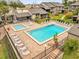 Community pool and spa with lounge chairs and brick patio at 670 Lake Villas Dr # D, Altamonte Springs, FL 32701