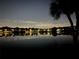 Water view with houses reflected on the water at night creates a tranquil ambiance at 670 Lake Villas Dr # D, Altamonte Springs, FL 32701