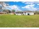 Large backyard with grassy area and home exterior view at 794 Scrub Oak St, South Daytona, FL 32119