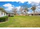 Large backyard with grassy area and home exterior at 794 Scrub Oak St, South Daytona, FL 32119