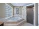 Clean bathroom with soaking tub and shower at 8835 Spyglass Loop, Clermont, FL 34711