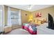 Charming bedroom with window and ceiling fan at 8835 Spyglass Loop, Clermont, FL 34711