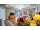 Spacious bedroom with wood floors and large window at 8835 Spyglass Loop, Clermont, FL 34711