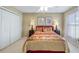 Cozy bedroom with ceiling fan and double closet at 8835 Spyglass Loop, Clermont, FL 34711