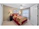 Comfortable bedroom with ceiling fan and window at 8835 Spyglass Loop, Clermont, FL 34711