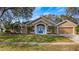 Attractive one-story home with a two-car garage and landscaped lawn at 8835 Spyglass Loop, Clermont, FL 34711