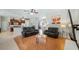 Living room with hardwood floors, black reclining sofas, and a view of the kitchen at 8835 Spyglass Loop, Clermont, FL 34711