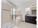 Bathroom with shower, tub, and dark wood vanity at 9218 Shepton St, Orlando, FL 32825