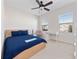 Spacious bedroom with double windows, a desk and a blue bedspread at 9218 Shepton St, Orlando, FL 32825