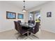 Dining room with dark wood table and chairs, and a view to backyard at 9218 Shepton St, Orlando, FL 32825