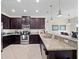Modern kitchen featuring dark wood cabinets, granite countertops, and stainless steel appliances at 9218 Shepton St, Orlando, FL 32825