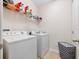 Bright laundry room with washer, dryer, and ample shelving at 9218 Shepton St, Orlando, FL 32825