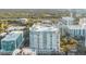 Stunning aerial view of a modern high-rise building in a vibrant city setting with lush greenery at 100 S Eola Dr # 1405, Orlando, FL 32801