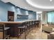 Inviting bar area with ample seating, sleek countertops, and recessed lighting at 100 S Eola Dr # 1405, Orlando, FL 32801