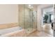 Bathroom area with a glass enclosed shower and tub at 100 S Eola Dr # 1405, Orlando, FL 32801