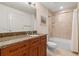 Well-lit bathroom with a tiled shower and tub combination, marble countertop vanity, and neutral colors at 100 S Eola Dr # 1405, Orlando, FL 32801