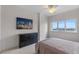 A modern bedroom boasts cityscape views, neutral tones, and a sleek dresser at 100 S Eola Dr # 1405, Orlando, FL 32801