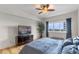 Bedroom featuring wood floors, a large window, and a TV on a dresser at 100 S Eola Dr # 1405, Orlando, FL 32801