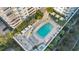 An aerial view of a community pool with chairs, umbrellas, and beautiful plants at 100 S Eola Dr # 1405, Orlando, FL 32801