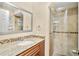 Bathroom showcasing vanity with granite counters and glass-enclosed shower at 1007 Baseball And Boardwalk Ct, Kissimmee, FL 34746