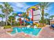 Resort-style pool with colorful water slides and lush landscaping perfect for a Gathering vacation at 1007 Baseball And Boardwalk Ct, Kissimmee, FL 34746