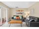 Cozy living room with two sofas, a unique coffee table, and sliding door to patio at 1007 Baseball And Boardwalk Ct, Kissimmee, FL 34746