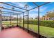 Screened patio featuring outdoor seating with a view of lush landscaping at 1007 Baseball And Boardwalk Ct, Kissimmee, FL 34746