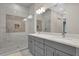 Modern bathroom with double vanity, large mirror and a walk-in shower at 1038 Jack Nicklaus Ct, Kissimmee, FL 34747