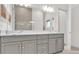 Double vanity bathroom with gray cabinets at 1038 Jack Nicklaus Ct, Kissimmee, FL 34747