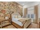 Main bedroom with floral wallpaper and a tufted headboard at 1038 Jack Nicklaus Ct, Kissimmee, FL 34747