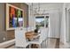 Elegant dining room with large wooden table and white chairs at 1038 Jack Nicklaus Ct, Kissimmee, FL 34747