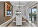 Bright dining room with wooden table, white chairs and pool view at 1038 Jack Nicklaus Ct, Kissimmee, FL 34747