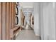 Long entry hallway with wood slat feature wall and modern art at 1038 Jack Nicklaus Ct, Kissimmee, FL 34747