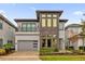 Modern two-story home with stone accents and a three-car garage at 1038 Jack Nicklaus Ct, Kissimmee, FL 34747