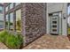 Modern front entrance with stone facade and glass door at 1038 Jack Nicklaus Ct, Kissimmee, FL 34747