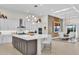 Modern kitchen with large island, stainless steel appliances, and white cabinets at 1038 Jack Nicklaus Ct, Kissimmee, FL 34747