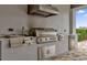 Stainless steel grill, sink, and refrigerator in an outdoor kitchen setting at 1038 Jack Nicklaus Ct, Kissimmee, FL 34747