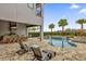 Inviting pool and spa area with outdoor kitchen and seating at 1038 Jack Nicklaus Ct, Kissimmee, FL 34747