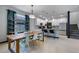 Kitchen and dining area with a wooden table and industrial-style chairs at 1101 Atlantic Ave, Fruitland Park, FL 34731