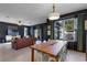 Bright dining area with a wooden table, view of living room and kitchen at 1101 Atlantic Ave, Fruitland Park, FL 34731