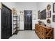 Entryway with wooden dresser, black doors, and eclectic wall decor at 1101 Atlantic Ave, Fruitland Park, FL 34731